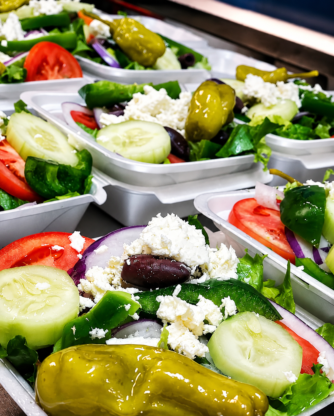 Fresh Greek salads prepared for pickup